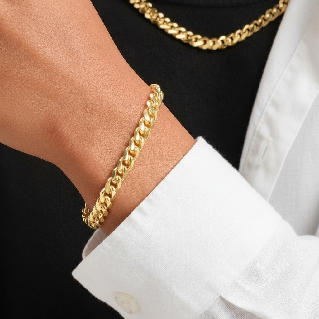Tyronea 8mm gold Cuban link chain and bracelet set made of stainless steel with a polished finish.