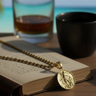 Tyrona gold stainless steel St. Michael Archangel pendant with rope chain. Detailed engraving symbolizes protection and strength.