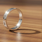 Tyrona women's Nova band ring in polished silver-tone stainless steel with precision-set zircon stones. 4mm band width.